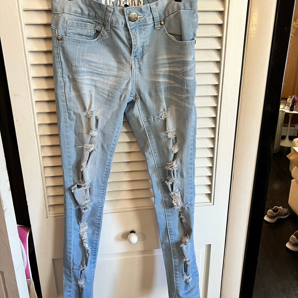 Light wash skinny jeans with holes all the way down
